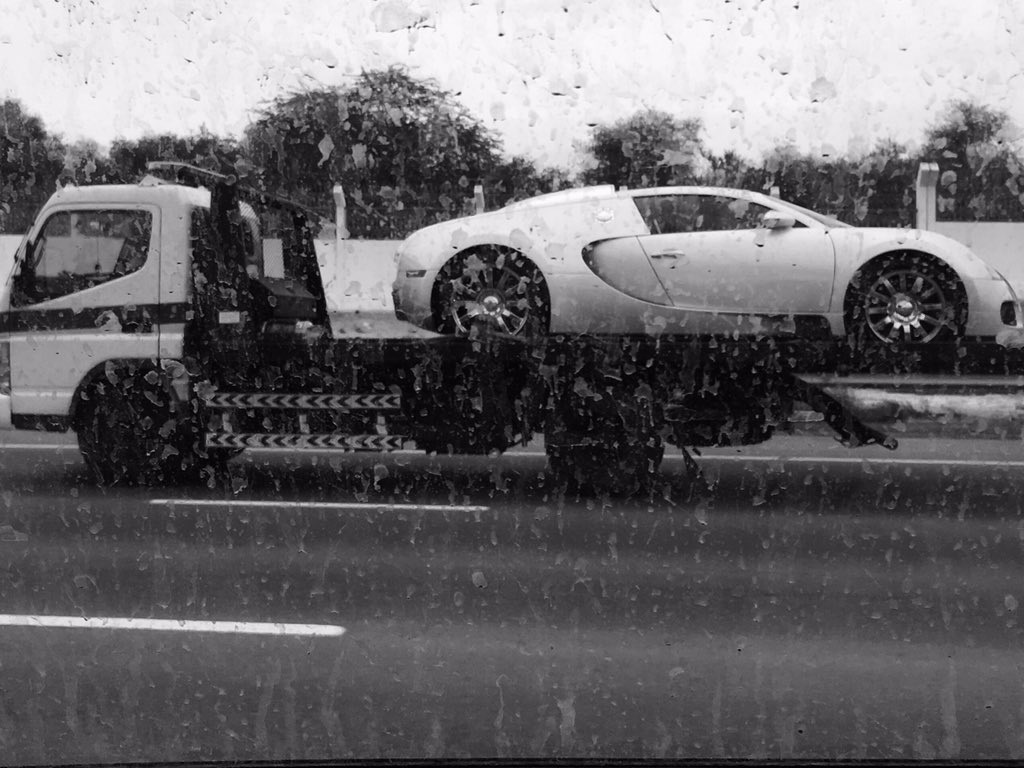 shawaz_mohammed's tweet photo. Nothing to look here .Just a lazy @Bugatti enjoying the rain. #RainInDubai #Dubai https://t.co/cdx7OF5vv2