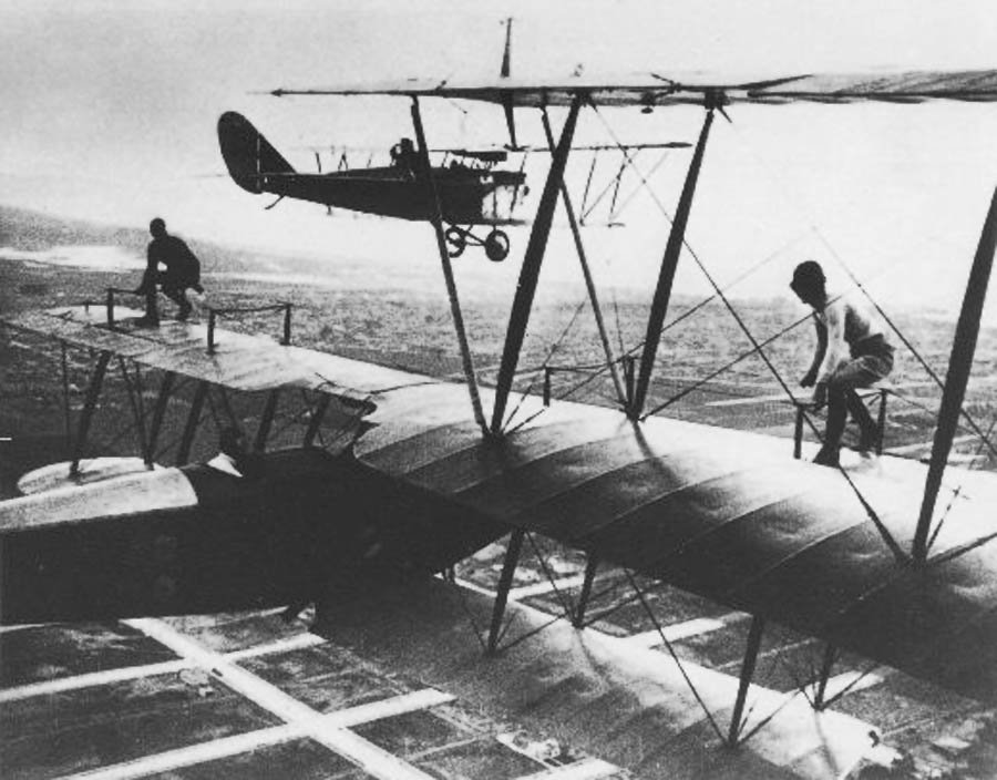 OTD 1921 first air-to-air refuel. Wesley May, 5-gallon gas can strapped to his back, wing-walked between planes.