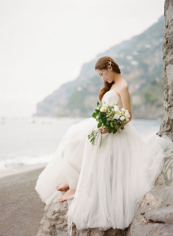 Beautiful @yuicolovessea sitting on the rock in Positano.