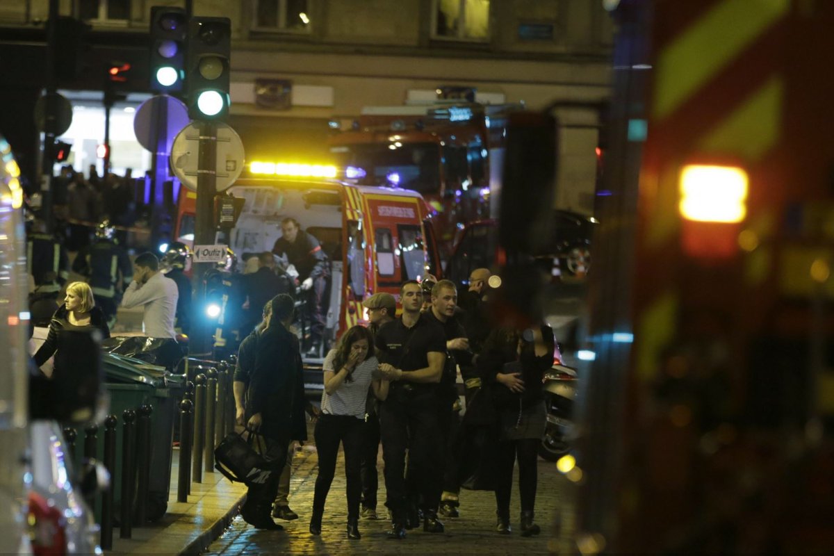 washingtonpost's tweet photo. Glimpses from the streets of the Paris attacks https://t.co/0J1wJPlMY6 https://t.co/nSlcHErfr5