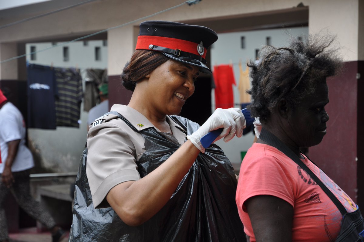 JamaicaConstab's tweet photo. Woman Inspector Jacqueline Grant offers her service as a hairdresser for the day, earlier today. #PoliceWeek2015 https://t.co/OGhzz3MVfz