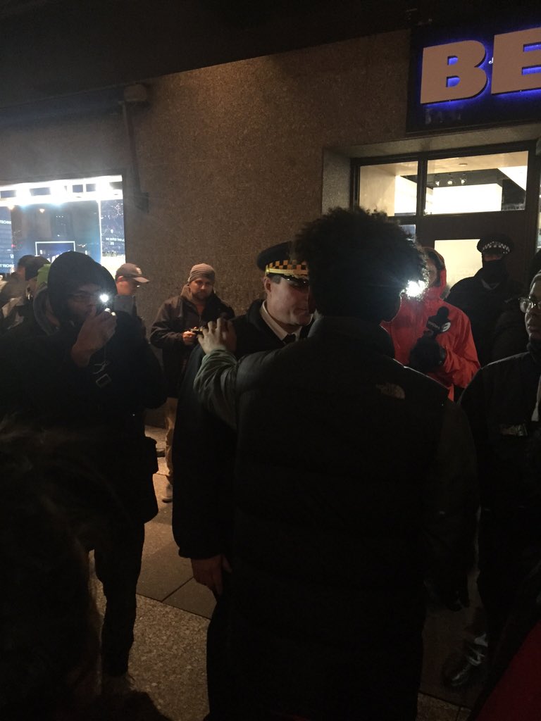 mitchtrout's tweet photo. Some protesters applauding CPD's protest detail, finishing night w/ handshake. #LaquanMcDonald https://t.co/YTJuyzYfJG