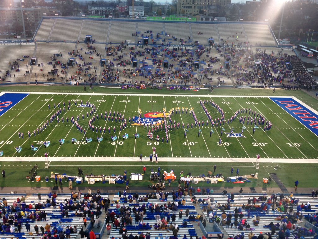 BentonASmith's tweet photo. KU band paying tribute to the Royals. Presumably to remind people sitting in cold/rain of happier times. #kufball https://t.co/UTiUs4PQjF