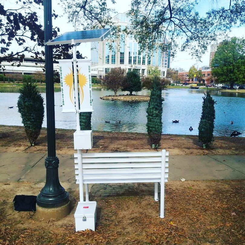 energyalabama's tweet photo. Solar charging park bench making a stop in @DowntownHSV for @TinselTrail. Thanks to Sun Charge Systems! #netzeroHSV https://t.co/dPXRHjWBNY
