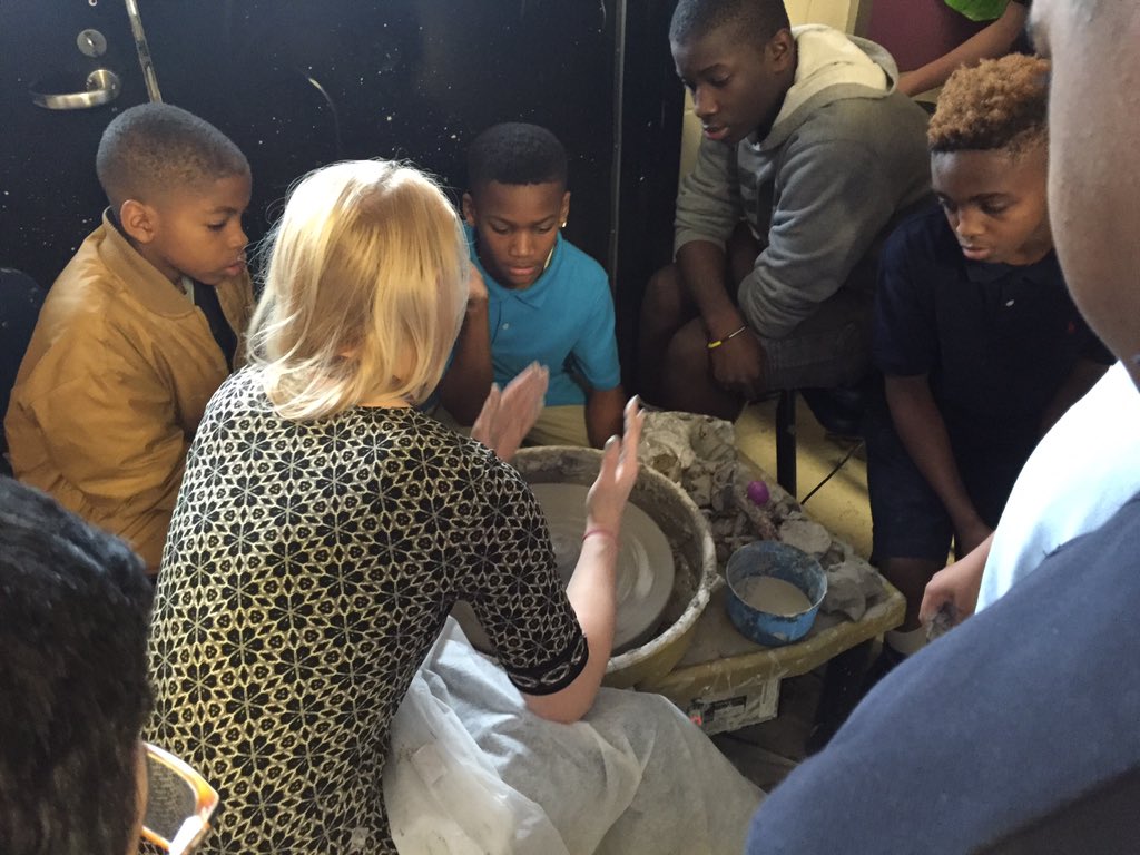Cooper MS Art teacher (Richardson) connects with her students teaching them about molding clay on a potter's wheel.