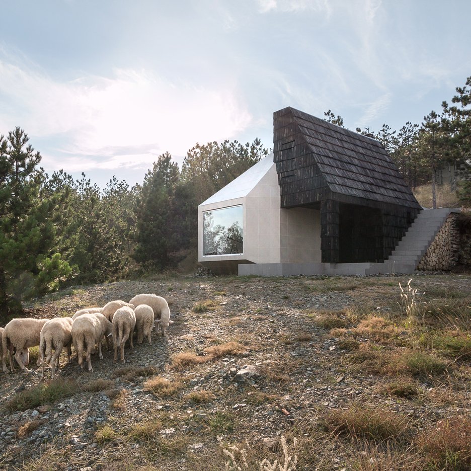 dezeen's tweet photo. Popular today: mountain home clad in both white ceramic tiles and dark wooden shingles https://t.co/923Lhh4GnD https://t.co/pv3OwNNMKT