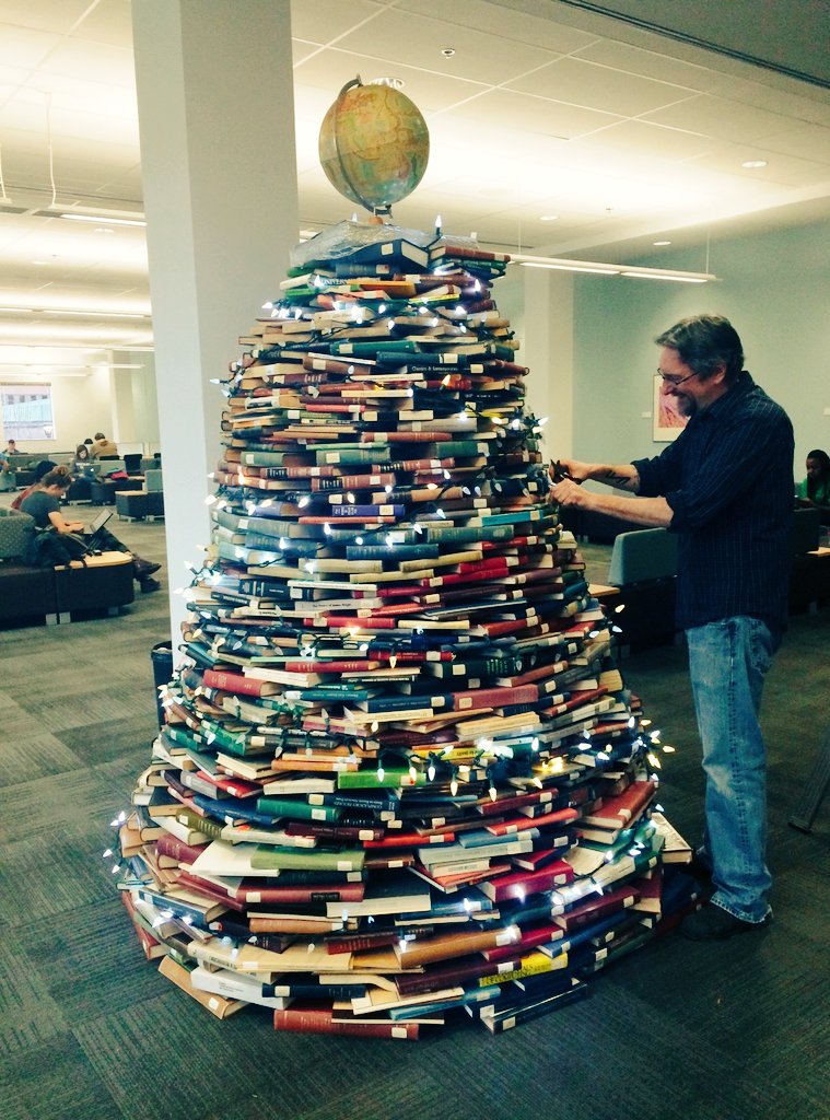 Holiday book tree is up in the library! Come check it out <a href="/CarletonLibrary/">MacOdrum Library</a>