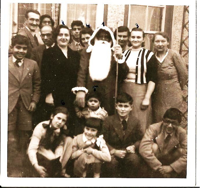 Naseemfk's tweet photo. Where are the brown or black Santas? Neither I (with cat) or my little bro Anwar thought this one (our dad) was fake https://t.co/LjBes5A71y