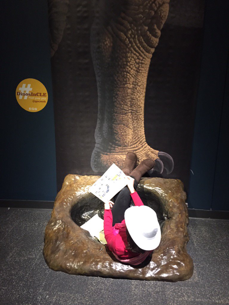 tinap17's tweet photo. Hanging out in a Dino's footprint... #DinosInCLE https://t.co/6B5WhJvqfB