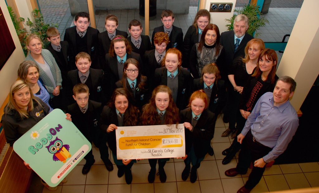 The EnglishDepartment,along with some of our biggest fundraisers present a cheque to @NICancerFund aftera Readathon