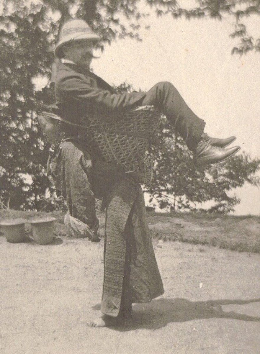A Sikkimese woman carrying a British man on her back, West Bengal, India, circa 1900.