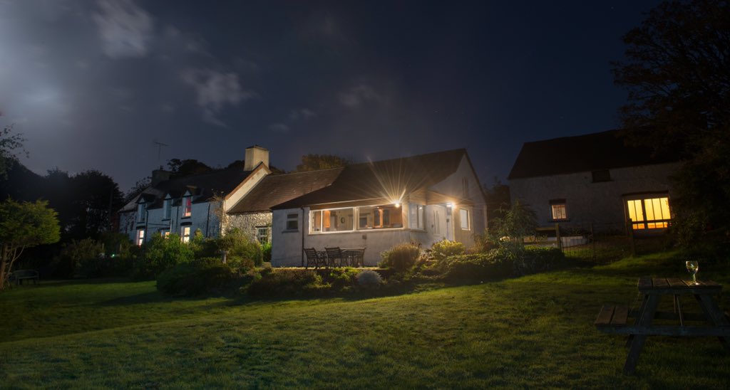 Our gorgeous farmhouse at night looking all cosy and inviting #WakeuphappyinWales #caruCeredigion