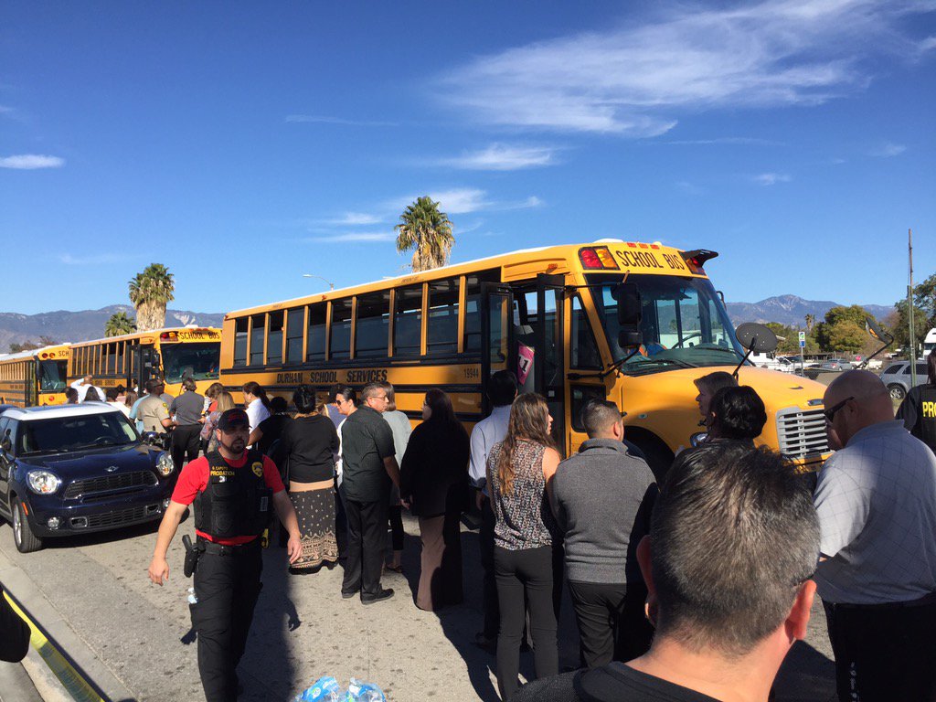 Buses line up to take San Bernardino shooting witnesses to a location to give statements. (Sarah Parvini / Los Angeles times)