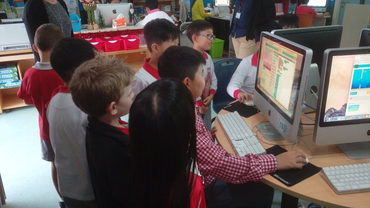 ron_milne's tweet photo. A 5-3 student completes a challenging level of coding as 1-1 cheers him on #TISMacao https://t.co/JDsMJoWGjS