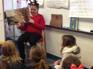 mrsdoll4's tweet photo. A student reads a book to the class as a reward for earning 10 Knight tickets.  Gr8 fluency practice!@KanelandKST https://t.co/wOouUOpKFT