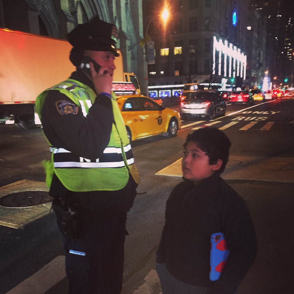 kimpestalozzi's tweet photo. This boy has tears in his eyes. I think he's lost. But this #NYPD cop's helping and keeping him safe #copsdoinggood https://t.co/VrK3V5FSCF