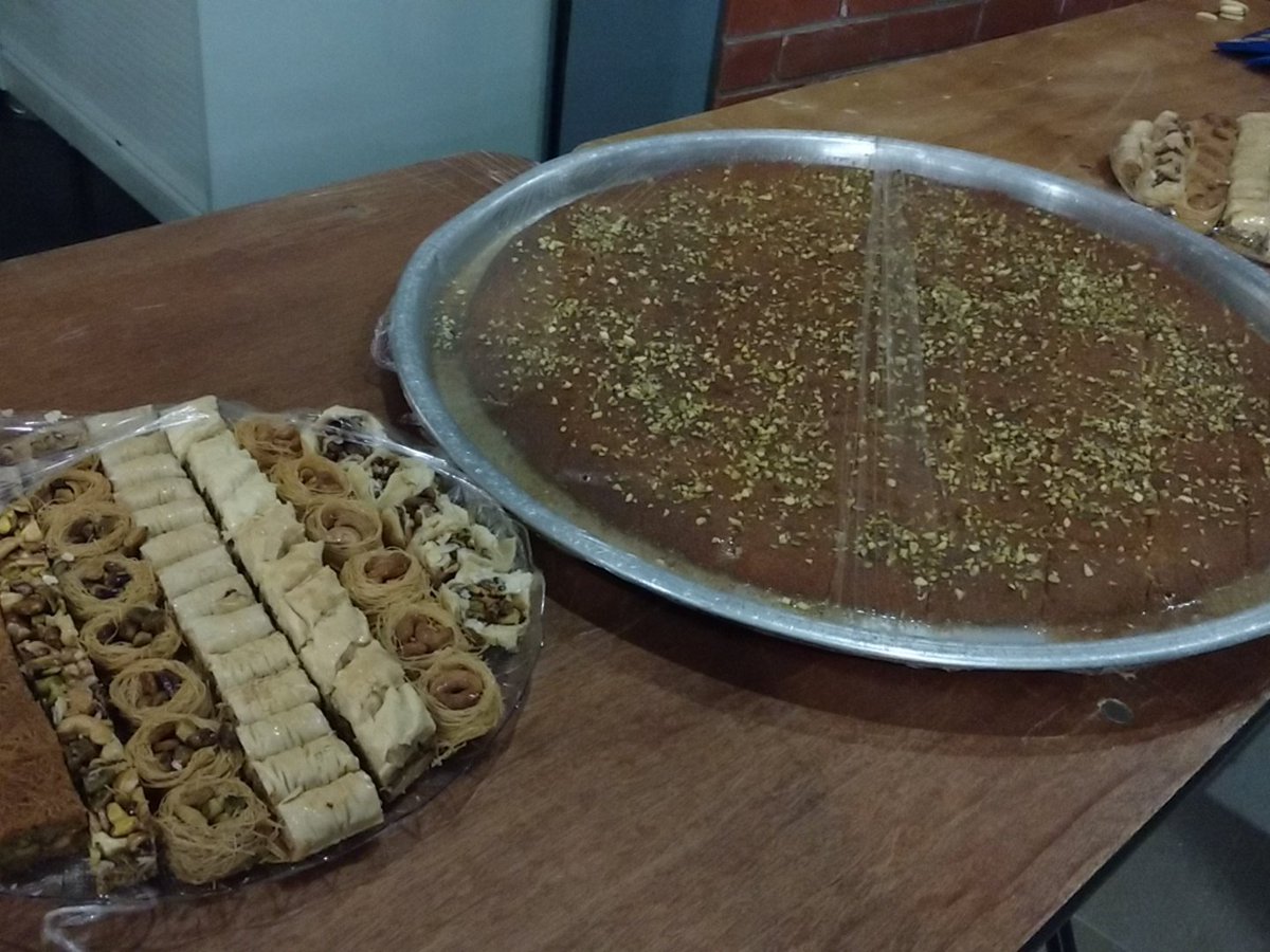 GreatUniHack's tweet photo. So this what happens when you have Syrian as organiser. #Kunafah #SyrianSweets https://t.co/pVmX1wWcm9