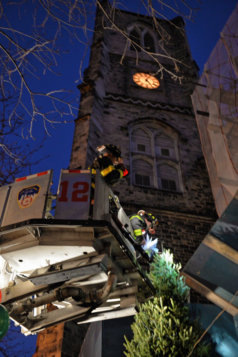 FDNY's tweet image. #FDNY #Ladder12 tops the #ChristmasTree at @stpeterschelsea where FDNY Chaplain, Reverend Harding, serves as pastor