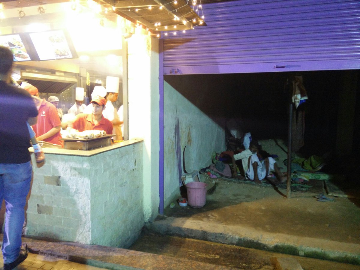 rubychandu's tweet photo. #dichotomy that is #india - a fast food joint thriving on the left &amp; a homeless family on the left #urbandivide https://t.co/bVVW4UtEGT