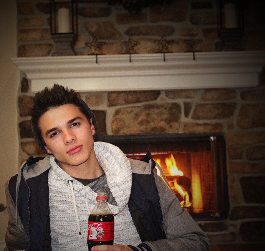Getting cozy by the fire. Who wants to #ShareaCoke under the mistletoe with me? Looking for someone nice #sponsored