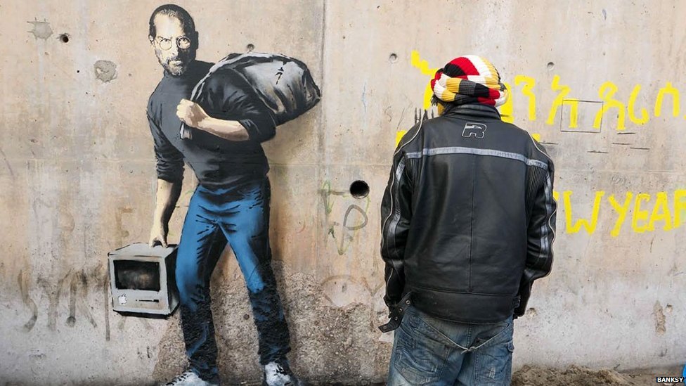 BBCWorld's tweet photo. Banksy depicts Steve Jobs as a migrant as a reminder of the benefits of migration https://t.co/EnFfzJzOZ3 https://t.co/nN2QiiUpIu