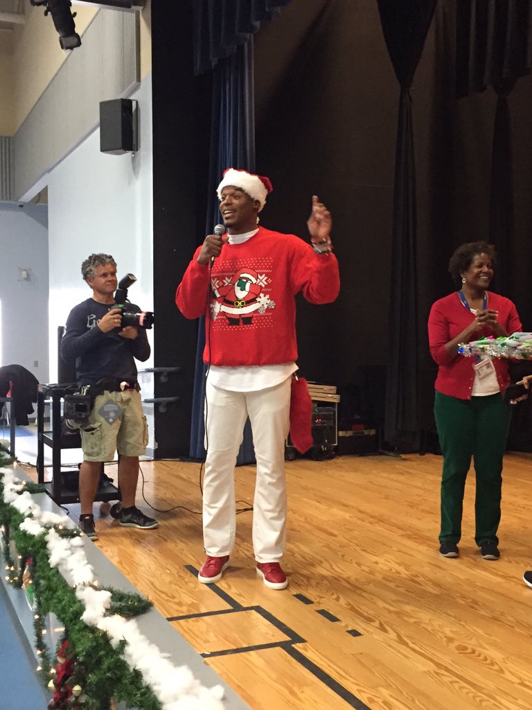 jjones9's tweet photo. Cam Newton is wearing a red dabbin Santa sweater with a red fox tail as he goes around town surprising kids https://t.co/WXeCOOsK3H