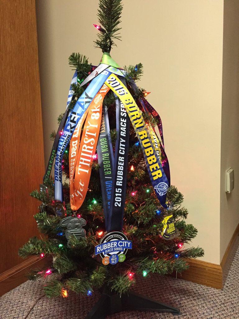 CindyPritt's tweet photo. My little tree downstairs has become my race medal tree. #rubbercityraceseries https://t.co/I5VnjS0wAF