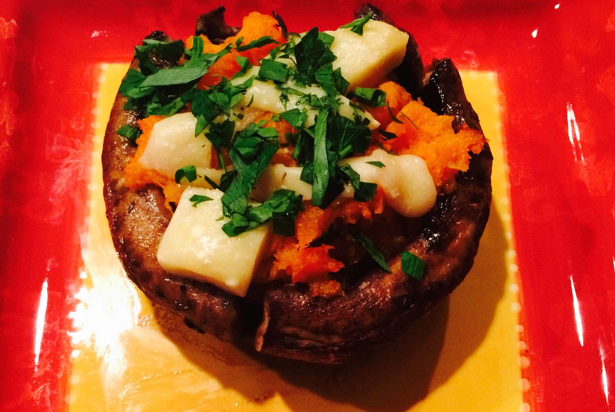 Stuffed portabella mushroom with butternut squash and topped with parmigiano reggiano cheese and fresh parsley.