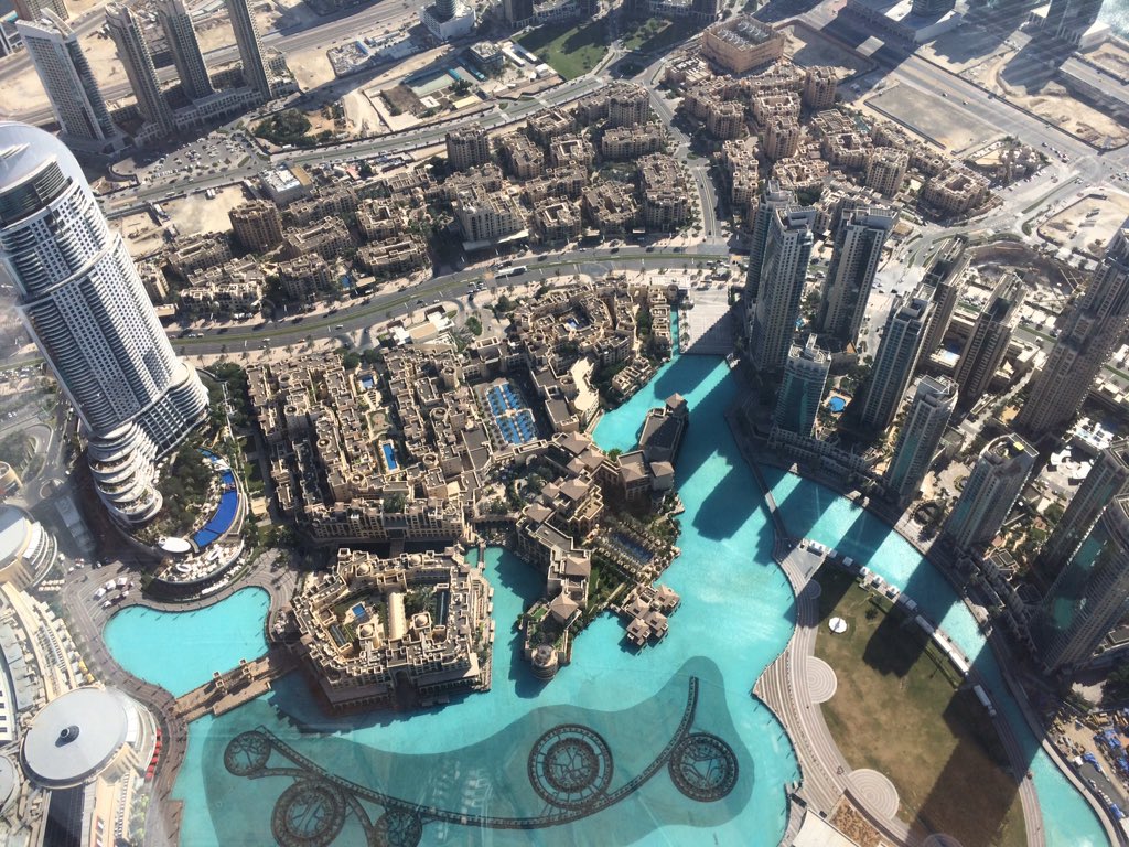 Squanch's tweet photo. View from the top of Burj Khalifa, the world's tallest building. It dwarfs those other buildings! #burjkhalifa https://t.co/Vzkith8ah2