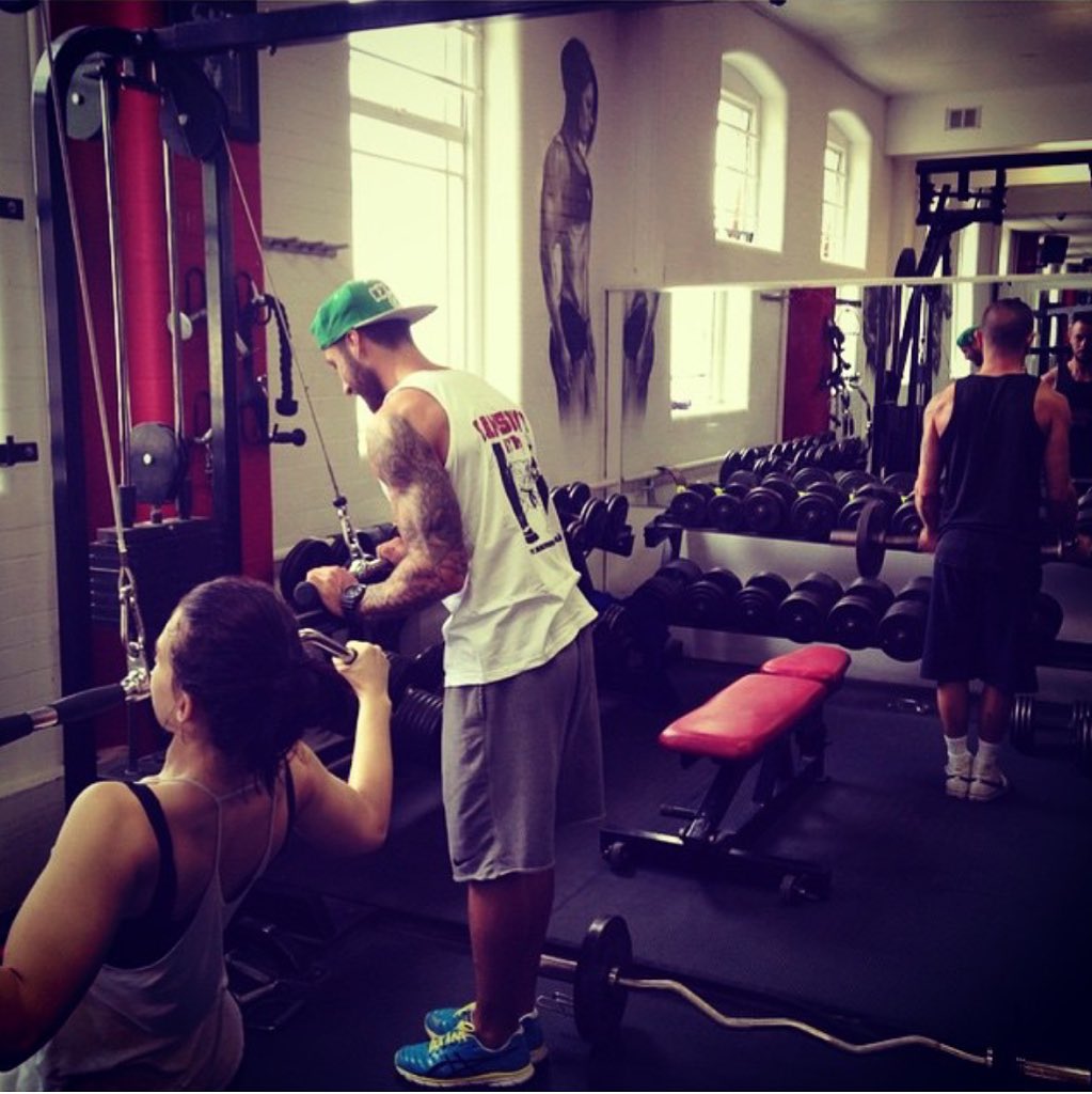 A few of our members and staff showing off some of the equipment and art work in the gym.