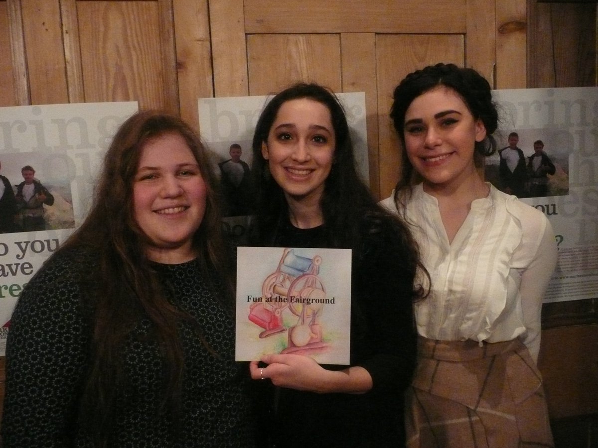 Three of our award winners (Liora, Natalia and Tamara) with a copy of their children's book "Fun at the Fairground"!