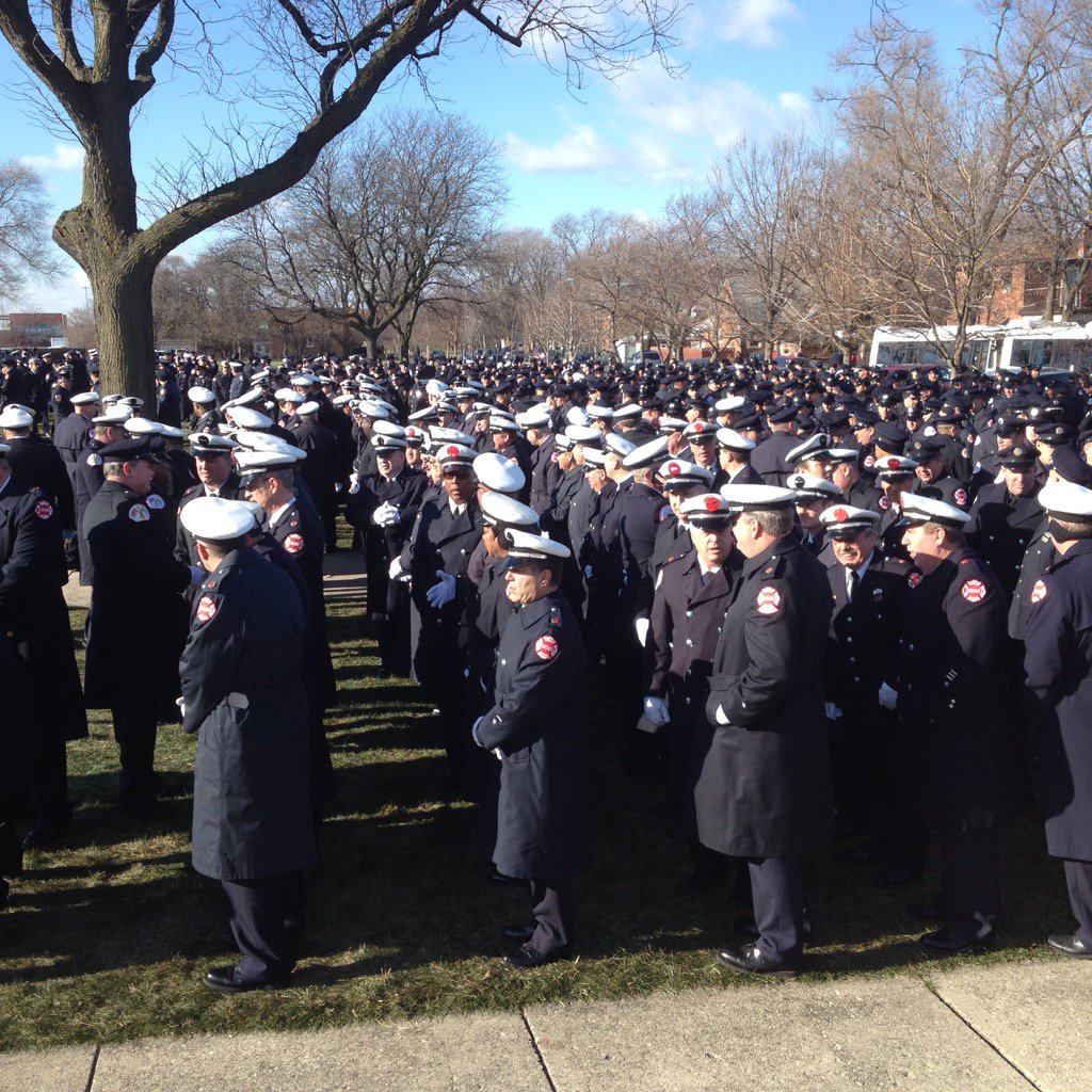 Firefighters outside St Rita await casket of  Dan Capuano to be brought out of chapel
