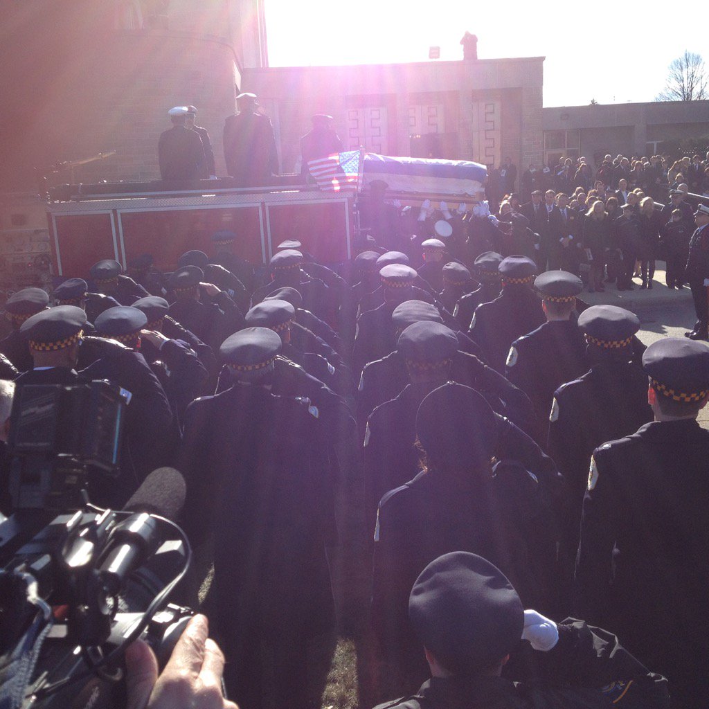 Casket of Firefighter Dan Capuano lifted onto fire engine outside St Rita