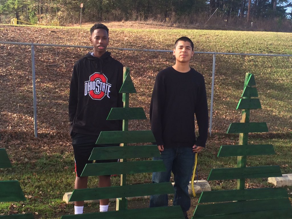 Oscar and Taylon with the pallet Christmas trees they built for the Food Service Ladies.