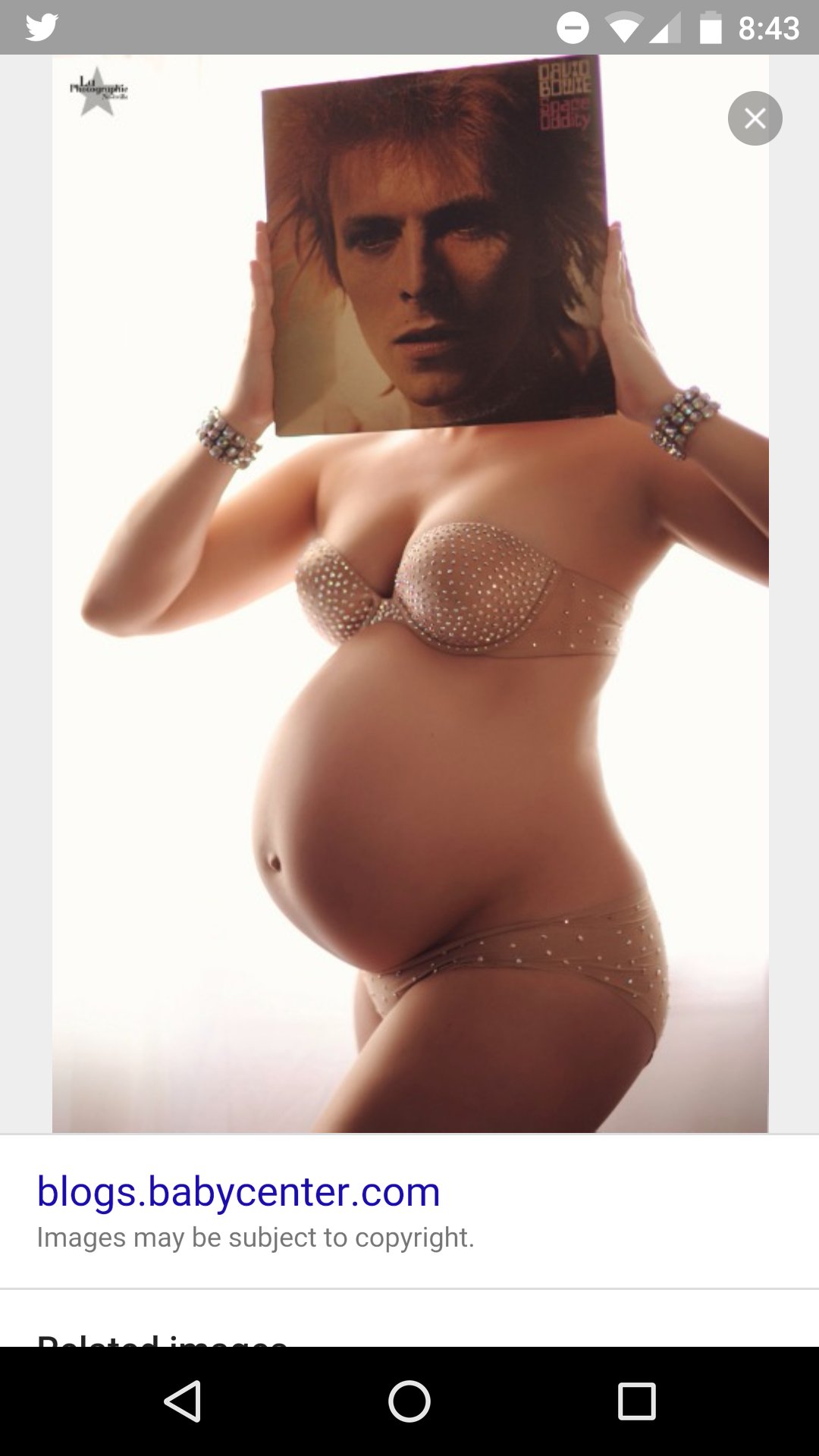   Happy bday Stu! This is a pregnant lady holding a David Bowie album over her face. 