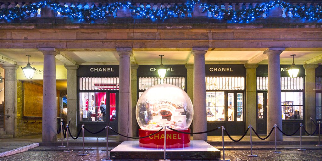 A giant replica of a red, Christmas-styled Chanel No 5 perfume