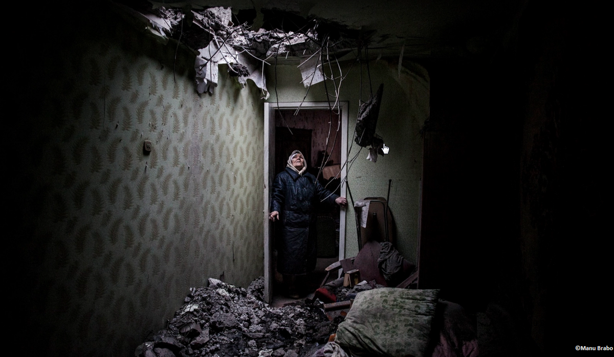 MSF's tweet photo. #MSF2015 #January: Galina, 86, looks at the hole where a shell hit her apt block in #Donetsk, eastern #Ukraine https://t.co/UWcEj5k9IG