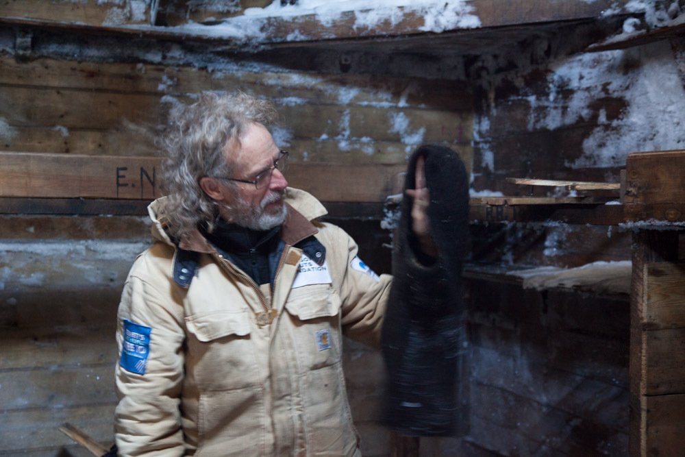 mawsonshuts's tweet photo. Mawson's Huts Foundation conservator Ian Godfrey with a balaclava found 
in @mawsonshut. https://t.co/a030zqMyZp