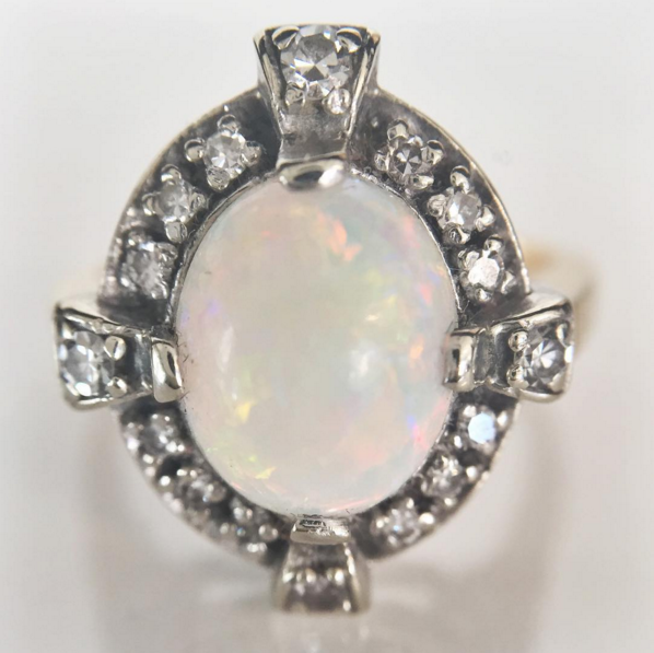 shopESQUELETO's tweet photo. This 1930s #vintage fire #opal ring in 14k white #gold setting w/ a #diamond halo. #shop: https://t.co/IIE2hlNm7F https://t.co/E3y0V6ZarO