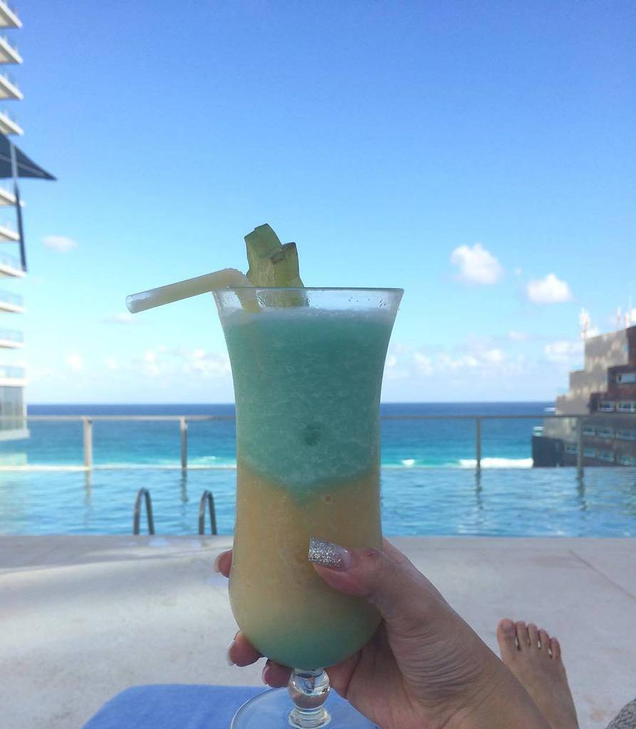 yucatango's tweet photo. This Pina Colada looks extremely refreshing. Bottoms up! #Cancun #Mexico https://t.co/3dX6Mb52RS https://t.co/voDqMbimSz