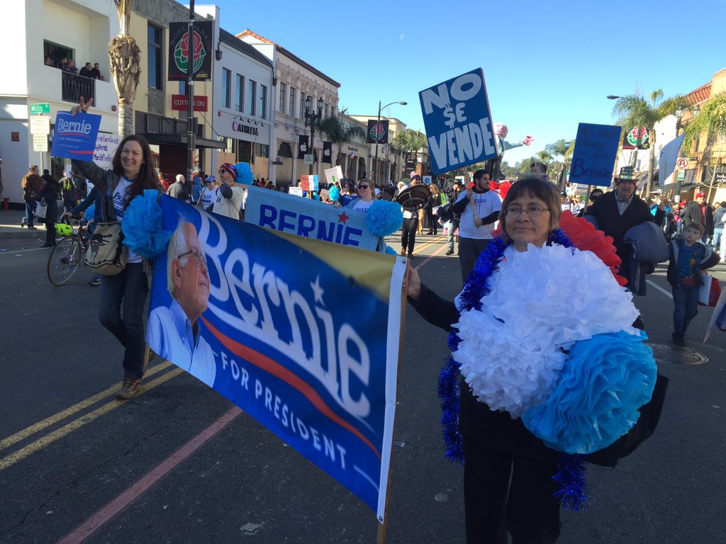 taygoldenstein's tweet photo. Pat Gracian (pictured right), 67, came all the way from San Diego to join the demonstration. #BernieRoseParade https://t.co/uN36gAQPXm