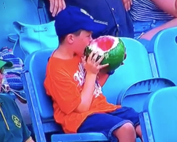 BR_Aus's tweet photo. A child eats a whole watermelon, including the rind, at the Big Bash #BBL05 🍉 https://t.co/JBXQ5b45c2 https://t.co/uUmHouNLOG