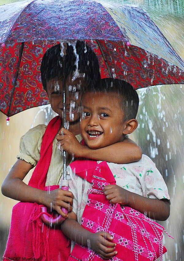 UNICEF's tweet image. Take a cue from these two schoolchildren in Myanmar. When it pours, smile. Enjoy your weekend!