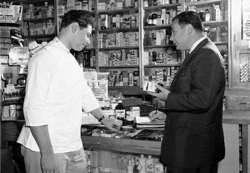 from the pfizer photo archives a sales rep detailing at a pharmacy pharmacy rep