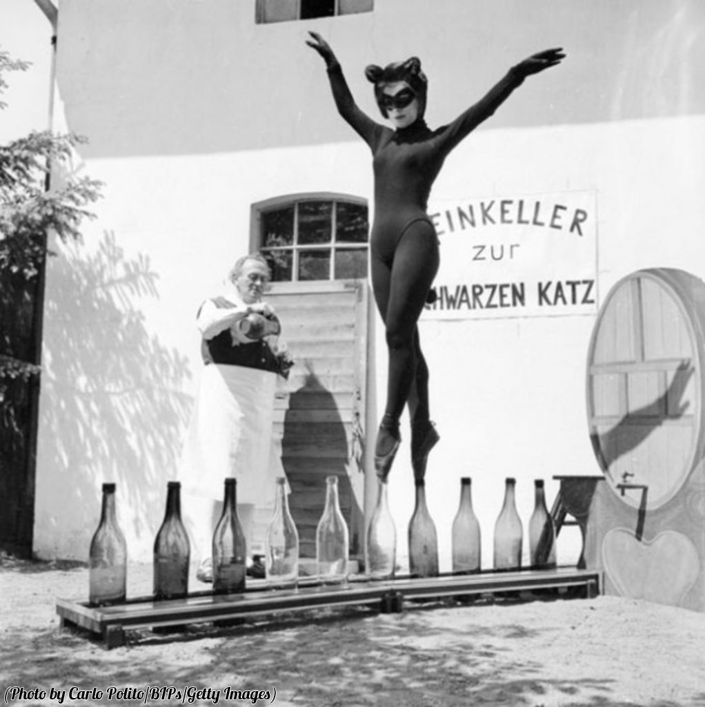 HistoryInPics's tweet photo. Inspired by a dream, 17 year old Bianca Passarge of Hamburg dresses as a cat and dances on wine bottles, circa 1958. https://t.co/yLMuZVC7C7
