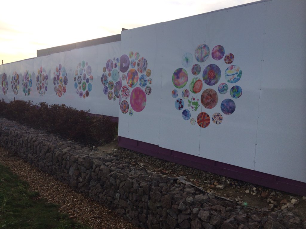 MandyPrintmaker's tweet image. Hoarding project at the Astra Zeneca site. The results of last years workshops. With @kjinksdesign