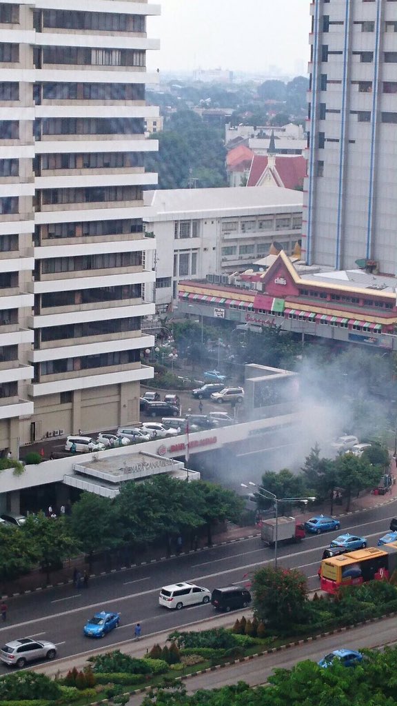 RT_com's tweet photo. BREAKING: Explosions, gunfire in central #Jakarta near UN agency office https://t.co/xkMLR04Vj1 (pic: @ReesEdward) https://t.co/KS0Kt1irzZ