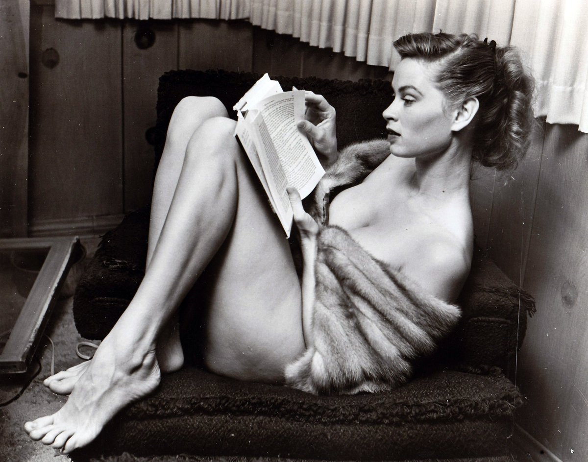 Irish McCalla curls up with a good book and a fur, 1955pic.twitter.com/Euij...