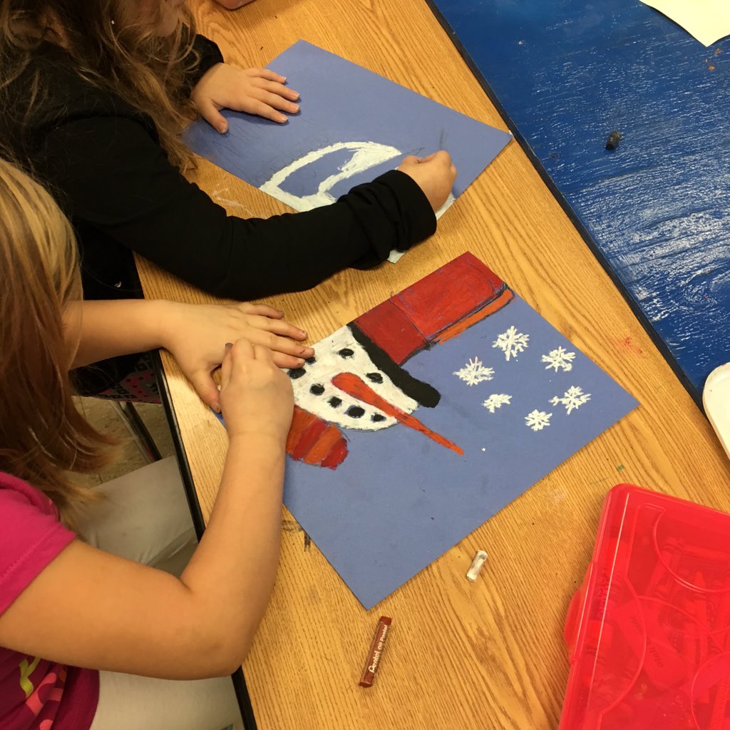 1st grade art students are busy creating the world's best snowmen with oil pastels