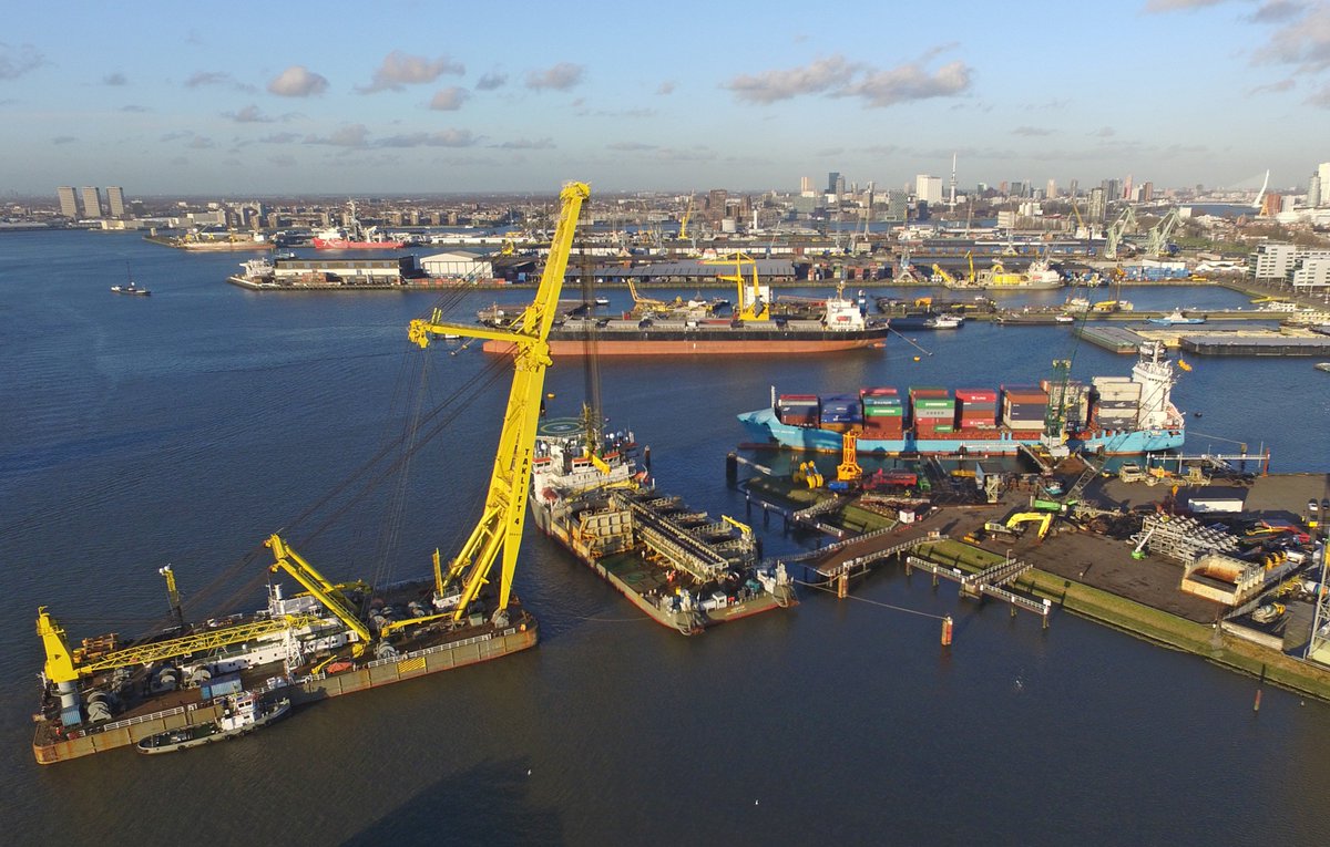 RdamOffshore's tweet photo. Heavy lift sheerleg Taklift 4 removing 180t stone holds from the multipurpose Ndeavor vessel of Boskalis. #NLRTM https://t.co/0VZ7CuCxUv